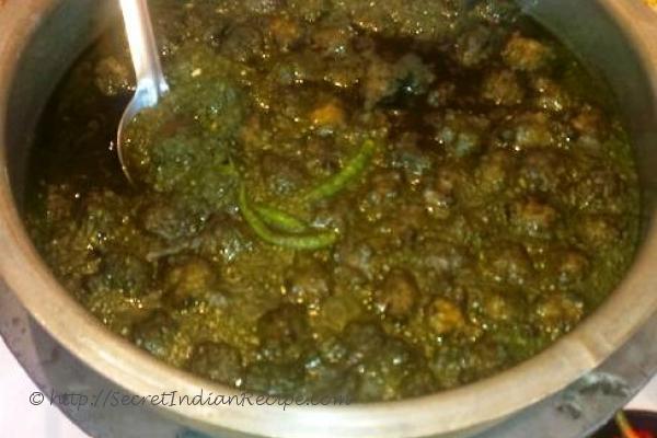 photo of noroxinho aru boror anja (lentil dumplings in curry leaves curry)