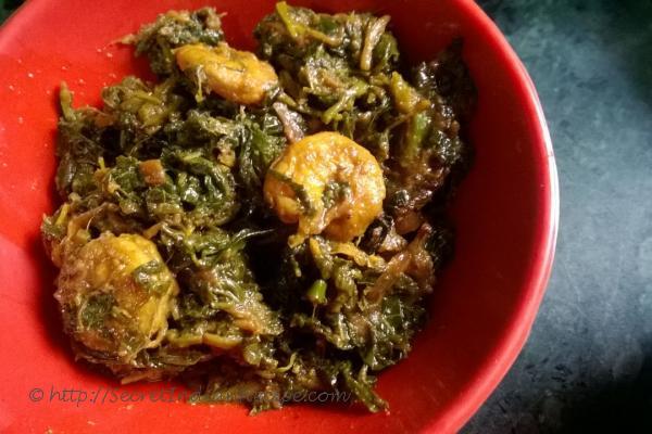 photo of saag chingri (prawns cooked with red spinach)