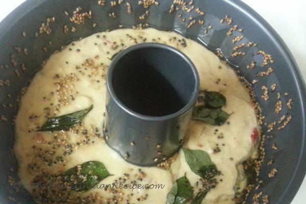 Handvo batter in the greased pan.