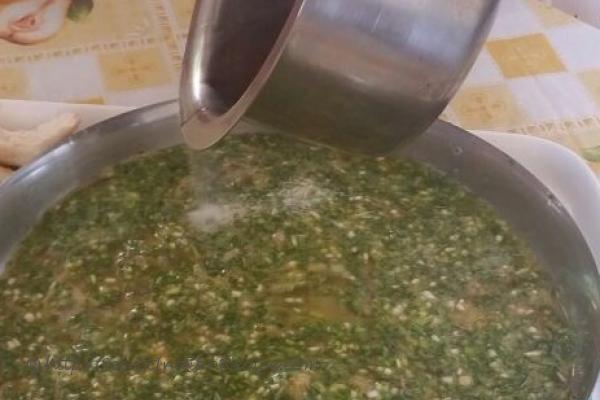 Sizzling ghee over green garlic beaten with eggs